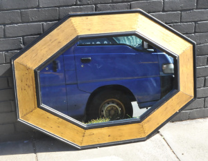 Lot 142 - Large heavy wooden oval octagonal shaped Mirror with Black & Gilt