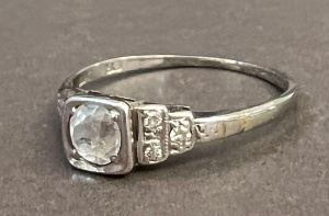 Lot 312 - 18ct Plat square set white Sapphire with 3 sm diamonds to each shoulde