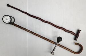 Lot 242 - 2 x Vintage wooden walking stick inc one with wheels & get out of