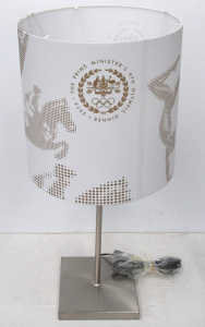 Lot 239 - Modern silver tone Lamp w original 'Prime Minister's 9th Olympic Dinne