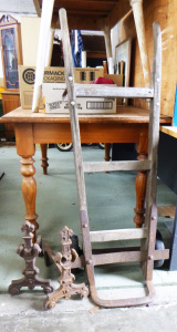 Lot 18 - 2 x Vintage items inc, a pair of Cast Iron Firedogs and wooden Goods Tr