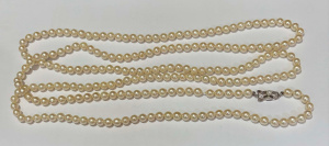 Lot 291 - Long strand cultured pearls with silver clasp - approx 148cms L