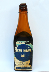 Lot 262 - Vintage Amber W Munro - Footscray Triangular glass bottle - Lawn Mover