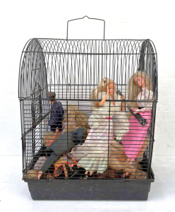 Lot 85 - Vintage bird cage full of Barbie & Kens