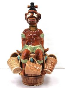 Lot 220 - 1950s Japanese Kitsch novelty Native Decanter & Mugs - Sitting on Lot 220 - 1950s Japanese Kitsch novelty Native Decanter & Mugs - Sitting on