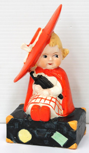 Lot 234 - 1930s Art Deco Japanese ceramic Figure - Girl sitting on suitcase with