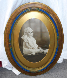 Lot 137 - Vintage Wooden convex Framed Photograph - Baby girl seated - carved bo
