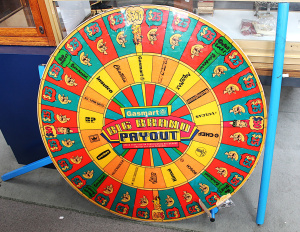 Lot 37 - Vintage Gasmart Big Brand Free Standing Prize Spinning Wheel with Metal Lot 37 - Vintage Gasmart Big Brand Free Standing Prize Spinning Wheel with Metal