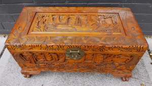 Light Stained Camphor Wood Chest with heavily carved stylised boating and fish s Light Stained Camphor Wood Chest with heavily carved stylised boating and fish s