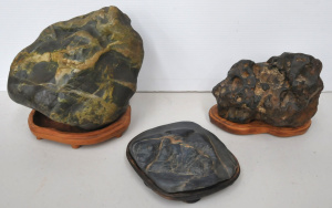 Lot 121 - 3 Japanese Suiseki stones on had carved timber stands (largest 23cm H
