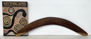 Lot 201 - Large carved boomerang depicting kangaroos and emu and softcover volum
