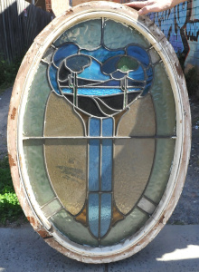 Lot 6 - Oval Art Nouveau lead light window in blue, green, and amber hues and de