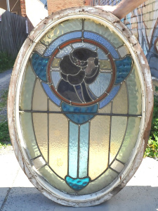 Lot 7 - Oval Art Nouveau lead light window in blue, green, and amber hues and de