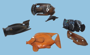 Lot 170 - Group of Trobriand Island carved fishes and dolphin in exotic hardwood