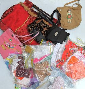 Lot 32 - Large group of vintage and modern dolls' clothes, a doll's high chair,