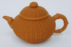 Lot 181 - Yixing Chinese clay teapot with bamboo and wicker design with maker's