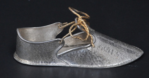 Lot 185 - Vintage White metal Eastern shoe ornament marked 900 with gilt bow 15c