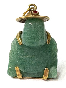 Lot 190 - Jade Buddha pendant set in 14ct gold, wearing hat set with red stone a