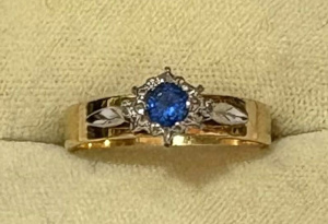 Lot 195 - 18ct gold ring with blue topaz surrounded by small diamonds and each s