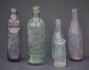 Lot 155 - 5 x vintage Australian embossed clear, green and purple glass bottles