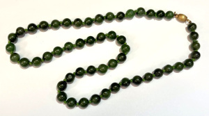 Lot 159 - Green jade nephrite knotted bead necklace with 9ct gold fastener marke