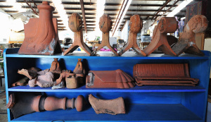 Lot 17 - Large group of vintage terracotta roof finials, tiles, and parts thereo