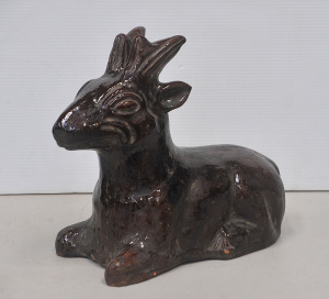 Lot 80 - Substantial vintage terracotta sitting fawn with Rockingham type brown