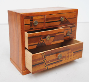 Lot 125 - Quality miniature chest of draws with various hardwood inlays in geome