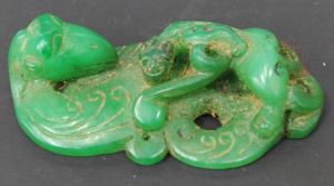 Lot 138 - Vintage Chinese jade carved pendent depicting a lion on the back of a