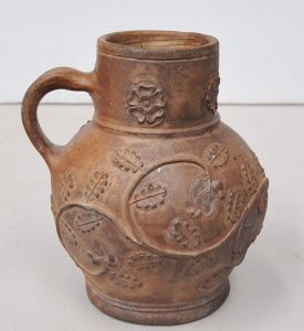 Lot 158 - Archaic German pottery jug with oak branch pattern - 15cm H