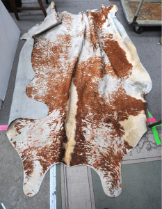 Lot 045 - Ayrshire cowhide rug - 220cm L - af damage, wear and staining sighted