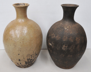 Lot 125 - A pair of vintage Chinese earthenware narrow necked vases embossed wit