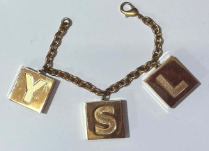 Lot 165 - YSL Bracelet with three charms containing highlighter, lip gloss, lips