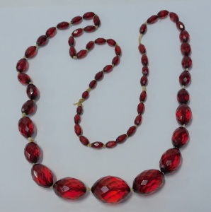 Lot 176 - Vintage necklace of graduated facet-cut red amber beads c1930s - appro