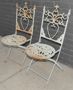 Lot 57 - Pair of ornate Victorian style cast iron folding garden chairs - 97cm H