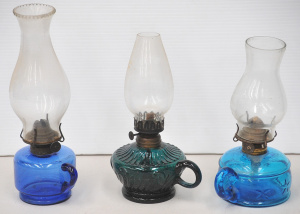 Lot 157 - 3 x Victorian handled oil lamps with various blue hued glass fonts - t