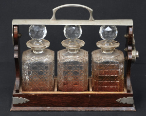 Lot 171 - c1920s Oak cased Lockable Tantalus set w 3 x Hobnail Cut Crystal Decan