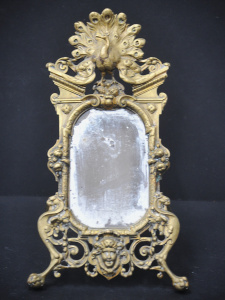 Lot 218 - Victorian cast brass framed vanity mirror with Herakles and peacock mo