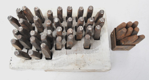 Lot 142 - Vintage set of steel letternumber punch stamps in home made wooden sta