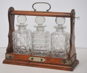 Lot 198 - Vintage oak and EPNS tantalus w 3 cut crystal decanters & key- 37c