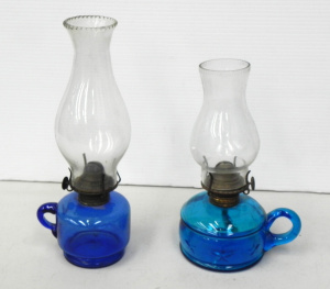 Lot 154 - 2 x Victorian blue glass finger lamps, one with embossed stars (taller