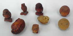 Lot 180 - Group of carved wooden and other owls, all with 2 holes pierced to bas