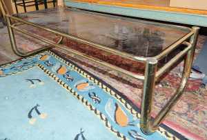 Lot 004 - 1980s brass finished tubular metal framed coffee table with smoked gla