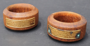 Lot 174 - Pair vintage Napkin rings with brass plaque reading - from the Teak of