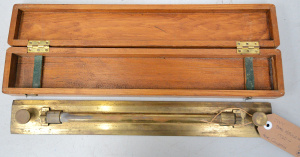 Lot 108 - 1920s boxed UVW brass rolling ruler (Birmingham) - box 48cm W