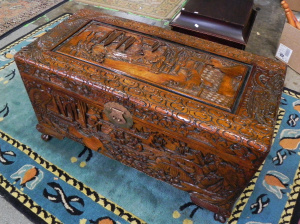 Lot 057 - Vintage heavily carved Eastern Camphor Chest, boating scene on the lid
