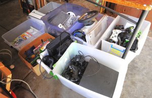 Lot 059 - Very large lot of 8 boxes of video game gear inc consoles Play Station