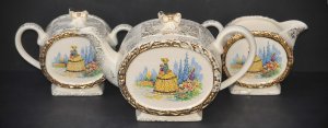 Lot 176 - Vintage Saddler Crinoline Lady tea set inc teapot (24 5cm W), sugar bo