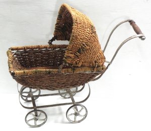 Lot 064 - c 1900 Wicker Dolls Pram with metal wheels & frame