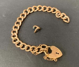 Lot 149 - Babies 9ct lined rose gold chain link bracelet with heart lock
